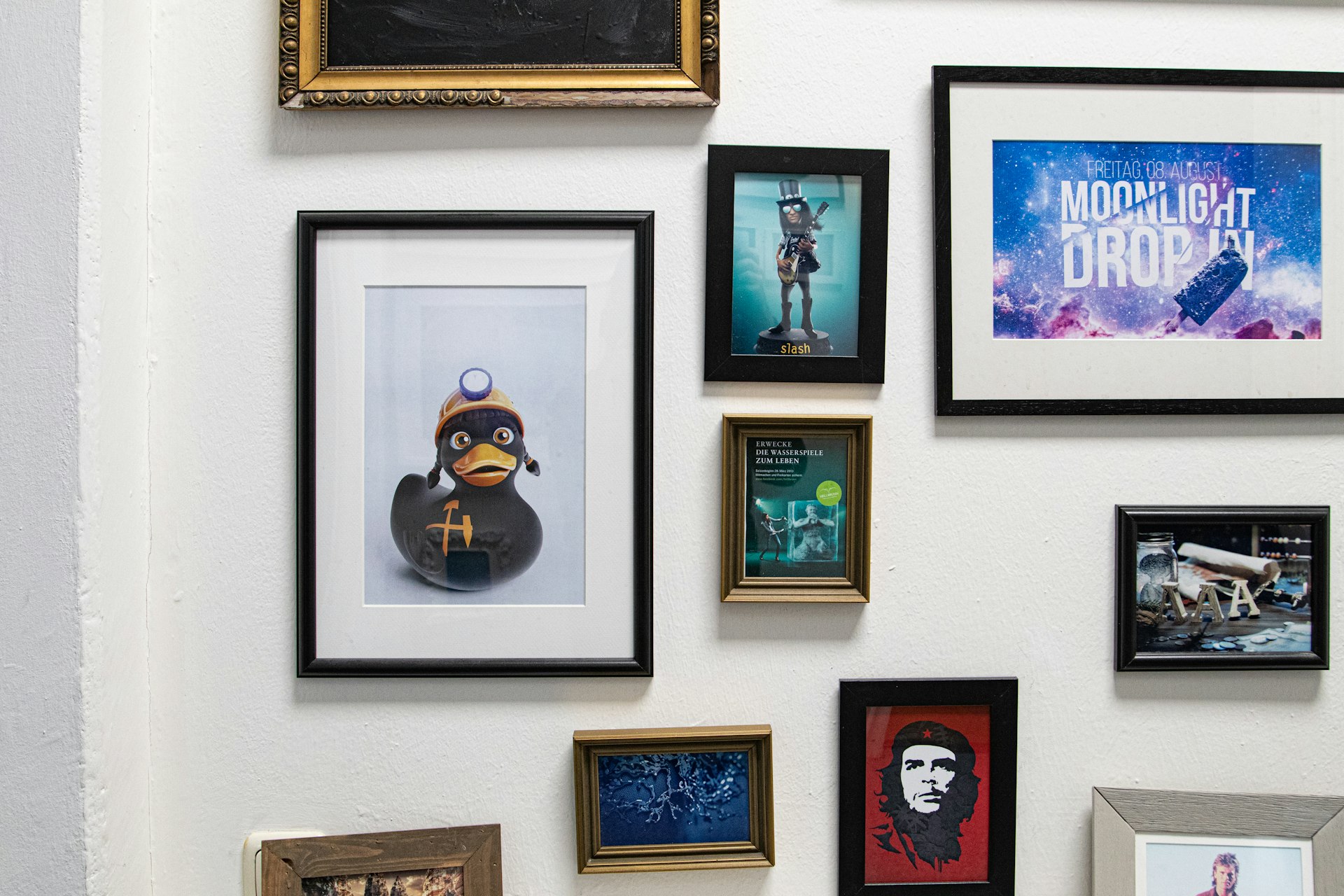 a bunch of framed pictures on a wall